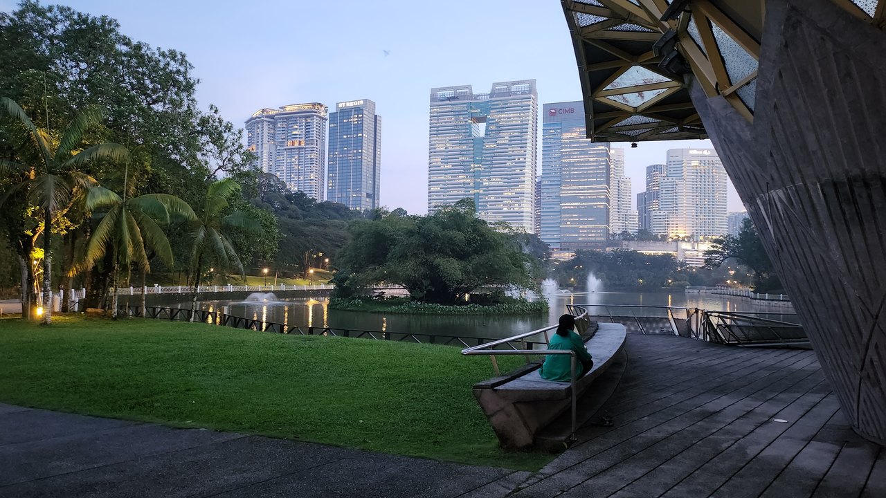 Green lawns and mature trees at a Kuala Lumpur botanical park